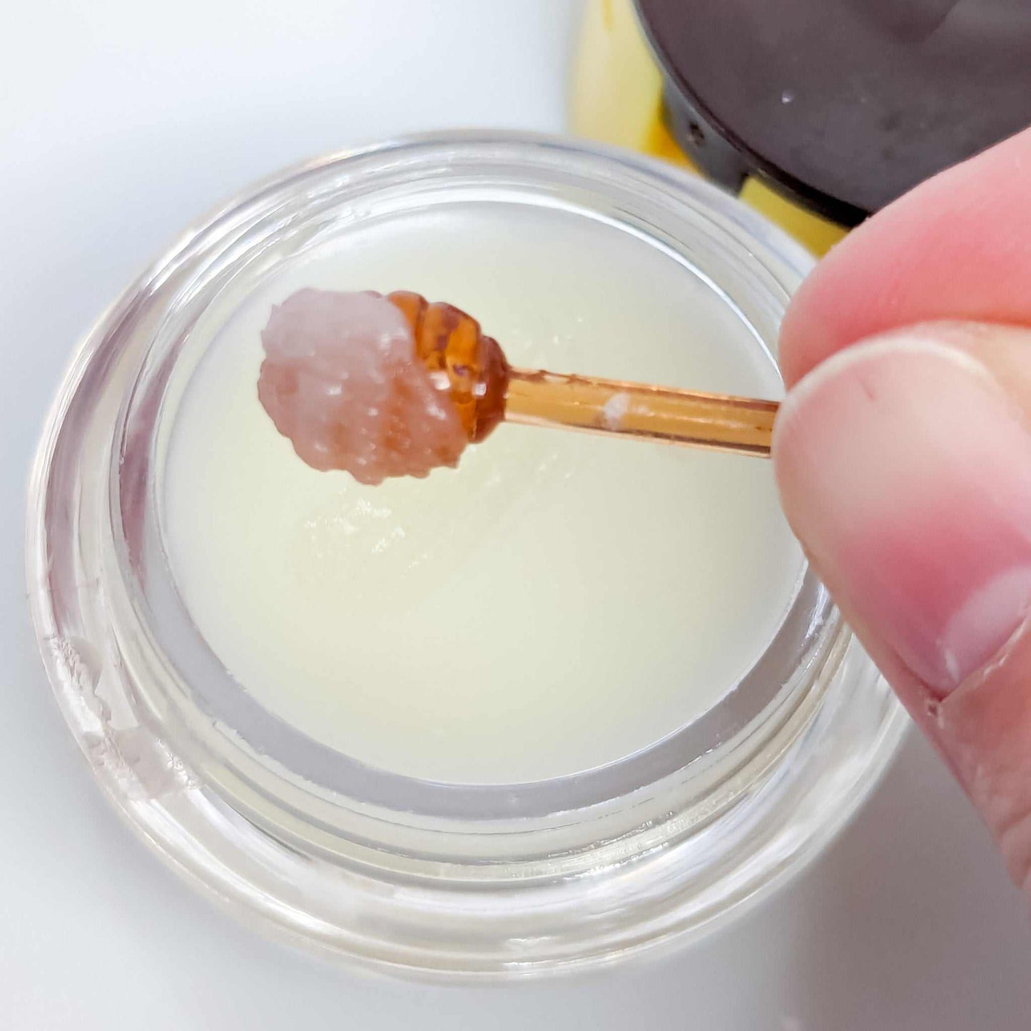Peppermint Lip Balm in jar with applicator, showcasing smooth texture and hydrating formula.