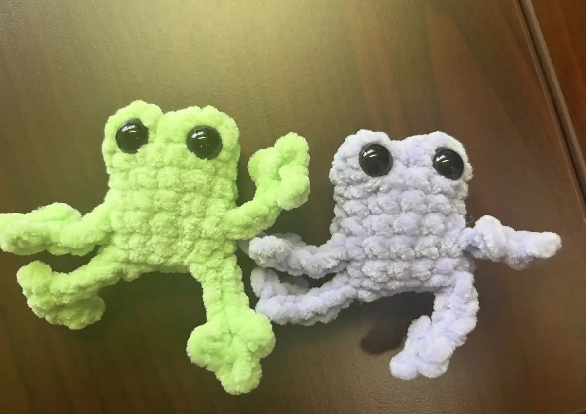 Two handmade crocheted baby frogs in lime green and light purple with black bead eyes for natural skincare canada gift
