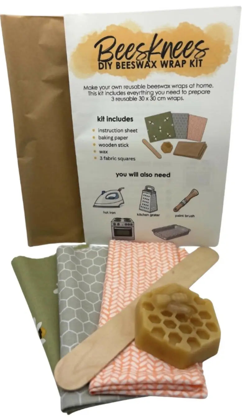 Beesknees beeswax wrap kit with honeycomb wax block, green gray orange fabric squares, instruction sheet, and wooden stick