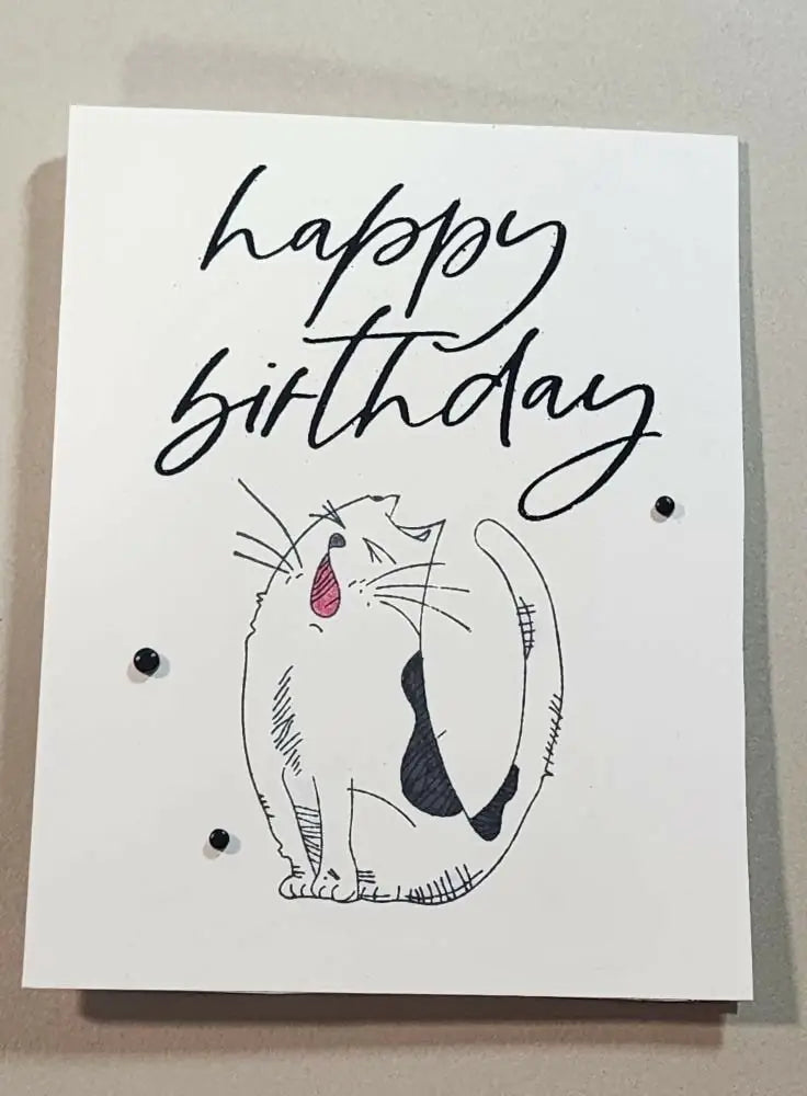 White birthday cat 1 card with handmade black ink sketch of yawning cat featuring pink tongue and dark gray patches with beads