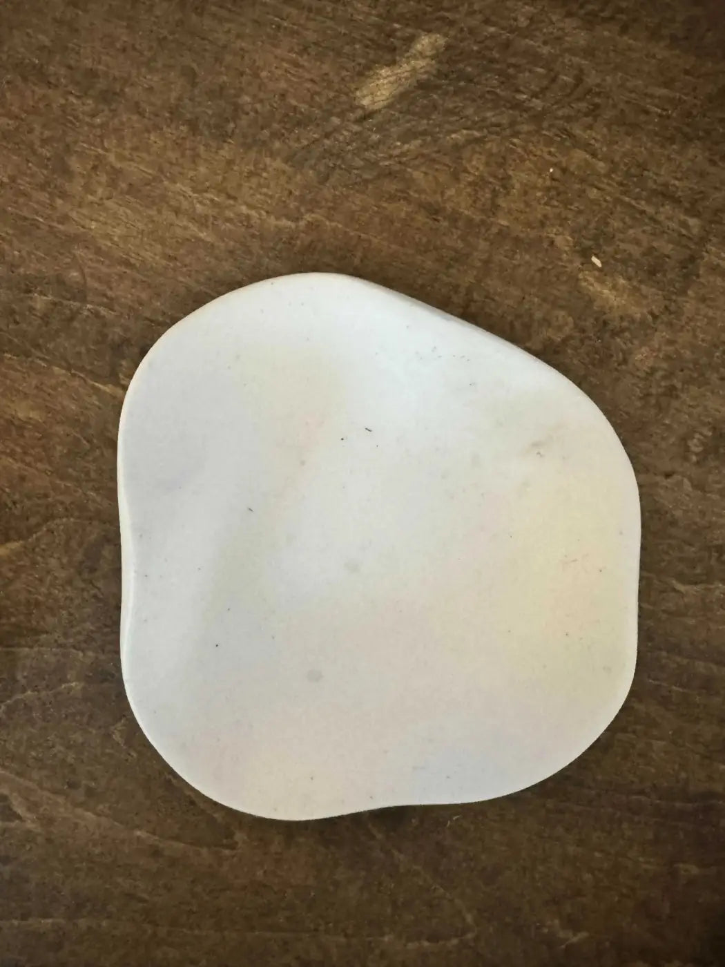 White smooth ceramic curvy ring holder soap dish with rounded edges and a slightly irregular shape