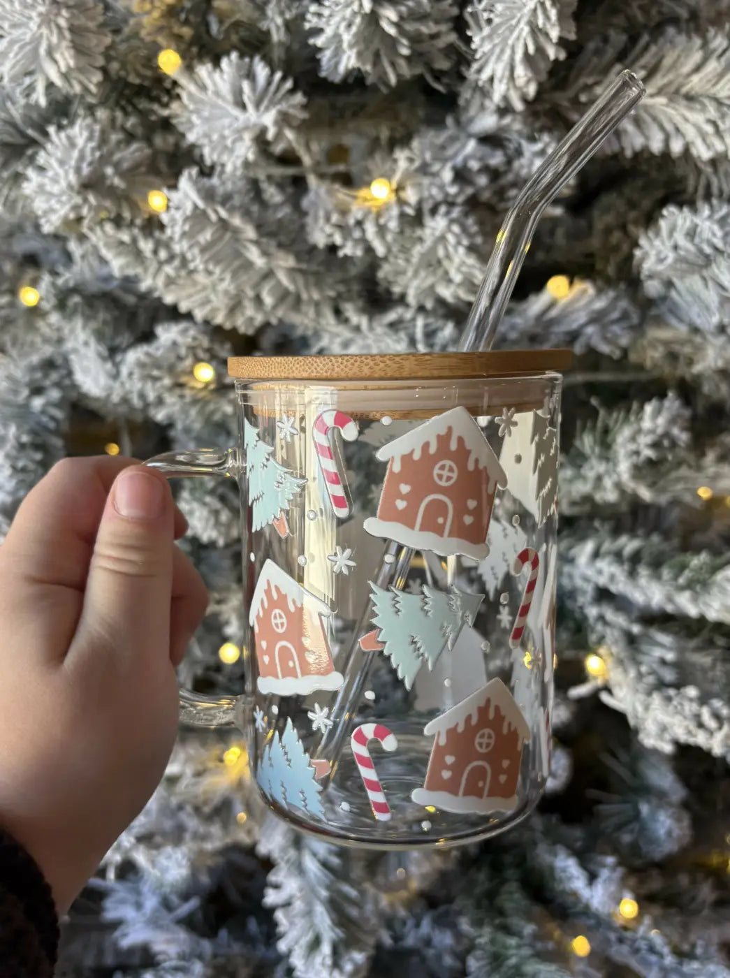 Clear glass gingerbread house mug with stylish bamboo lid and handle, decorated with festive candy cane decals