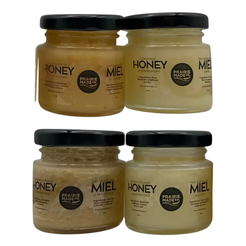 Four glass jars of Prairie Made Co limited edition Canadian honey in the holiday honey sampler featuring Manitoba wildflower honey