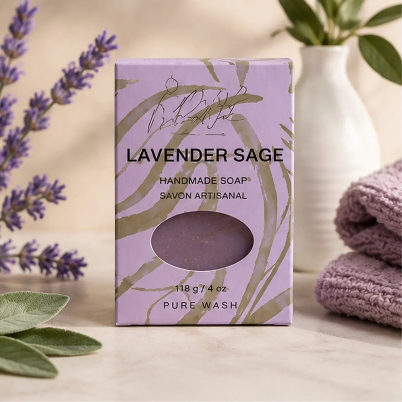 Lavender sage soap bar in lavender and gold foil box with oval window revealing purple handmade soap with clary sage and palm oil