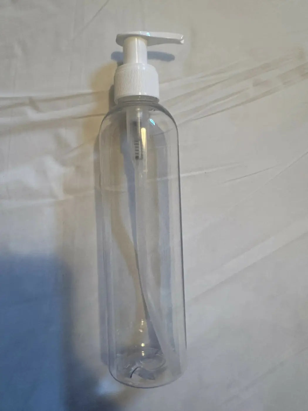 Clear plastic pump bottle with white dispenser ideal for canadian made skincare and natural skincare canada products