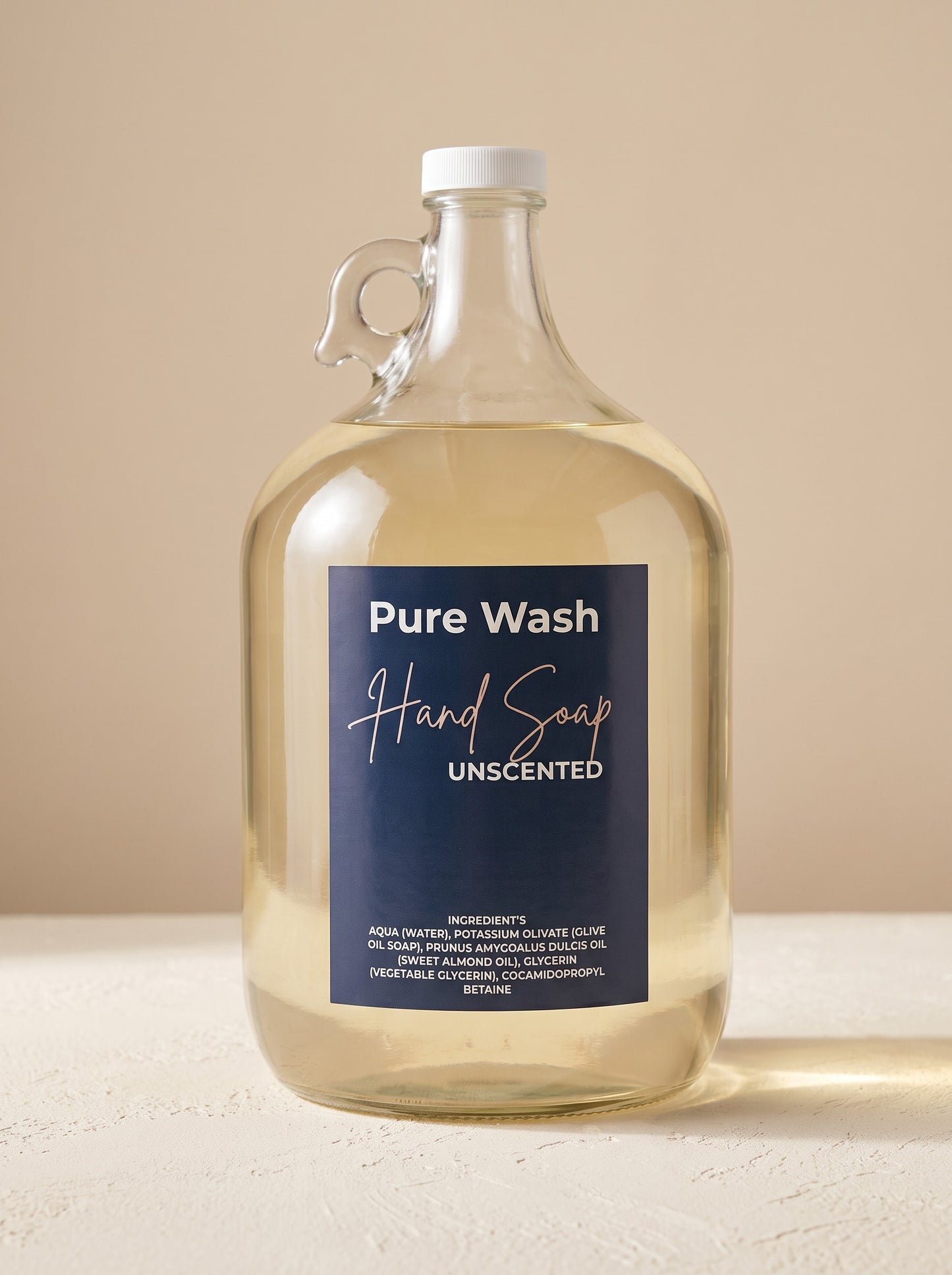 Pure Wash unscented plant-based liquid hand soap in a large glass refill jug with a navy blue label.