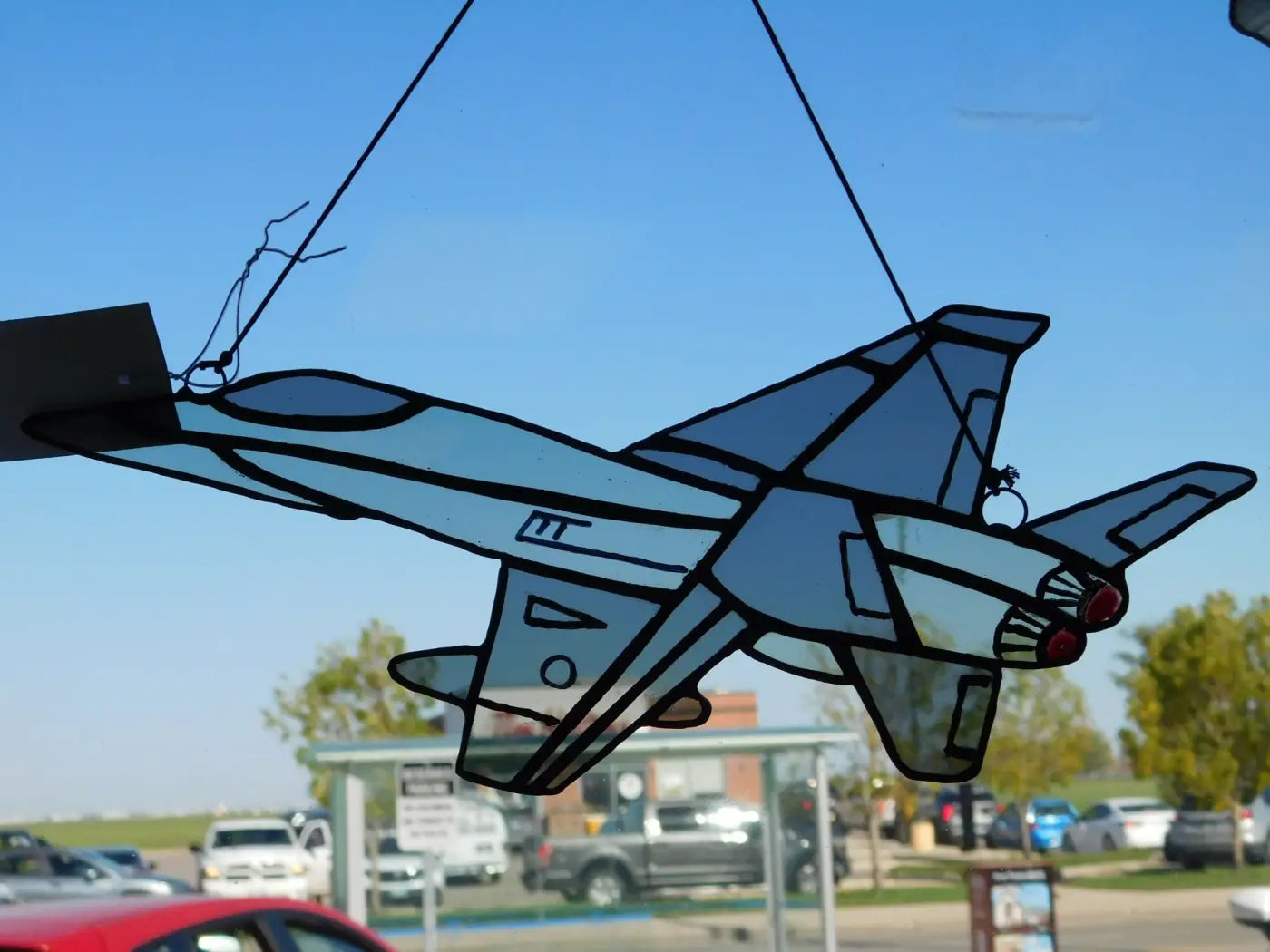 Blue stained glass cf-18 two toned grey jet hanging ornament featuring a detailed fighter jet design