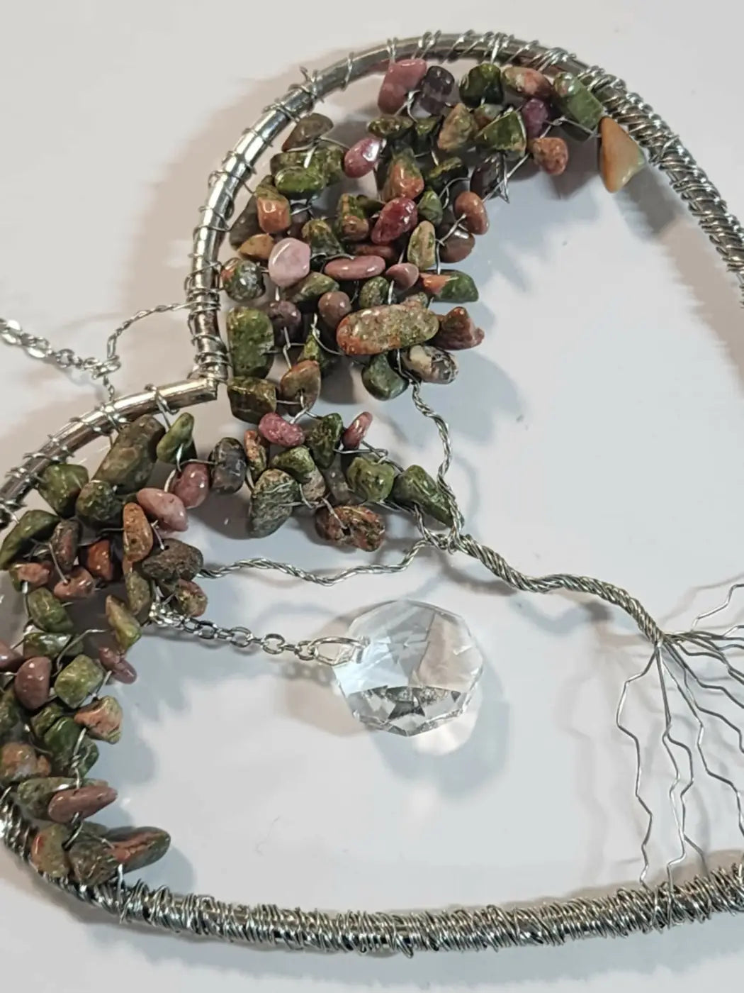 Tree of life heart suncatcher with multicolored green pink and brown river stones and a clear crystal pendant as small reflective light catcher