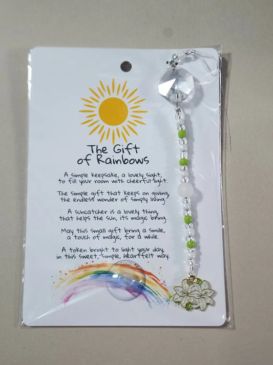 A small flower sun catcher with clear crystal top green white beads and gold flower charm ideal for canadian made skincare spaces