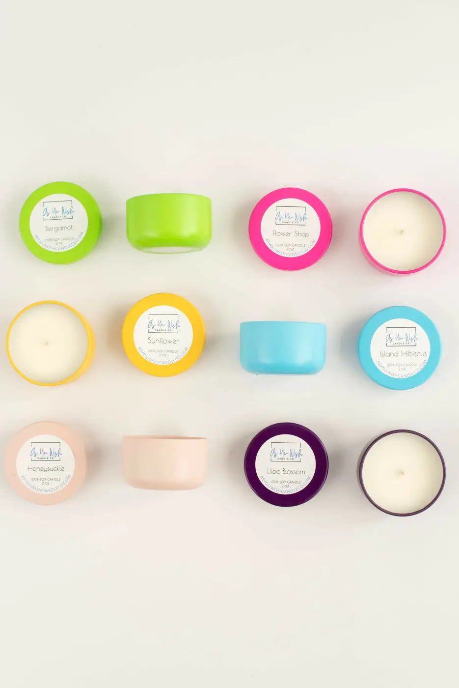 Brightly colored mini soy wax candle tins in lime green pink yellow blue peach and purple with white wax inside