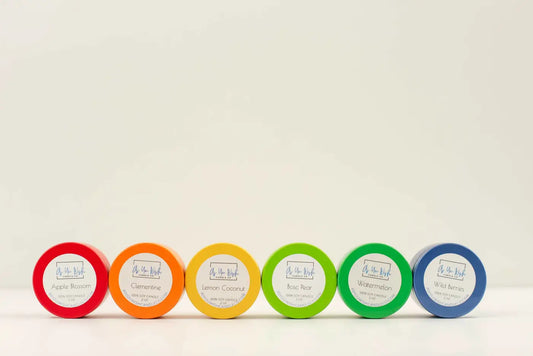 Six colorful 2 oz mini soy wax candle tins in red orange yellow green and blue ideal as small soy candle gift canada