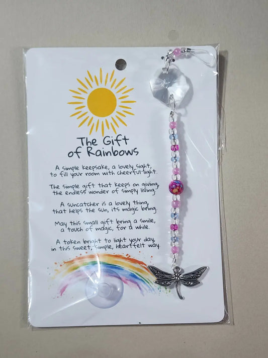 A delicate pink and clear beaded suncatcher with a silver dragonfly charm, ideal for canadian made skincare spaces
