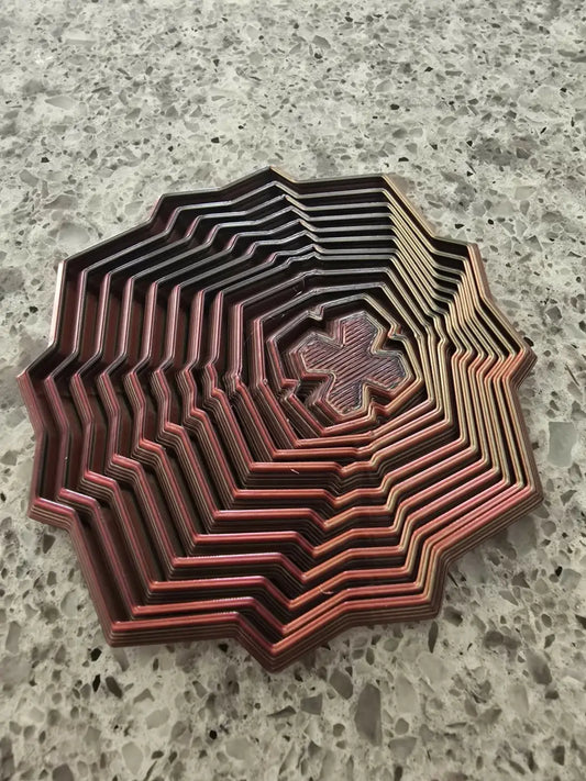A multi-layered octagonal 3d printed fidget star with zigzag edges and coppery red concentric rings wooden sensory toy