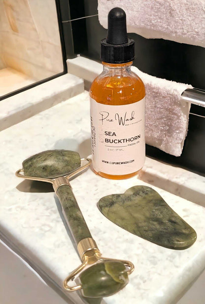 Jade Facial Kit including Sea Buckthorn Oil, Jade Roller, and Gua Sha on a vanity counter.
