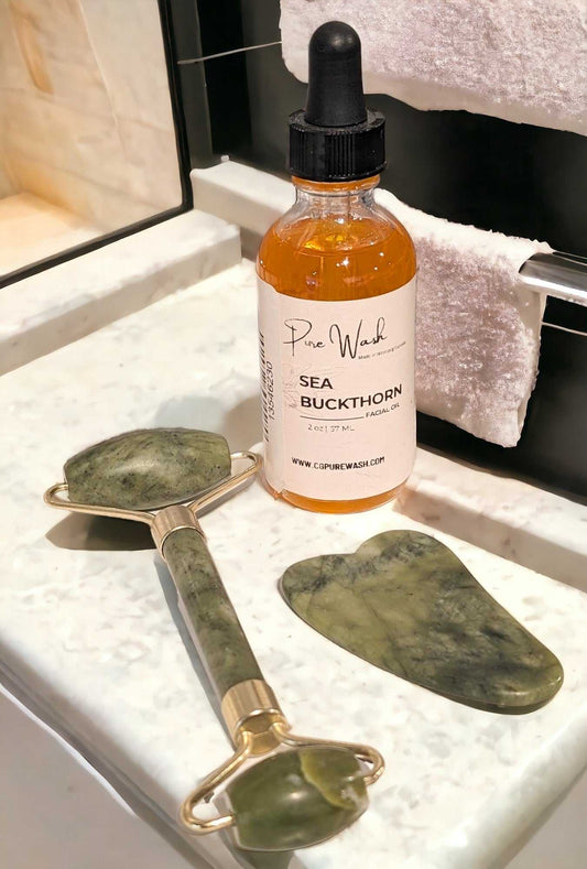 Jade Facial Kit including Sea Buckthorn Oil, Jade Roller, and Gua Sha on a vanity counter.