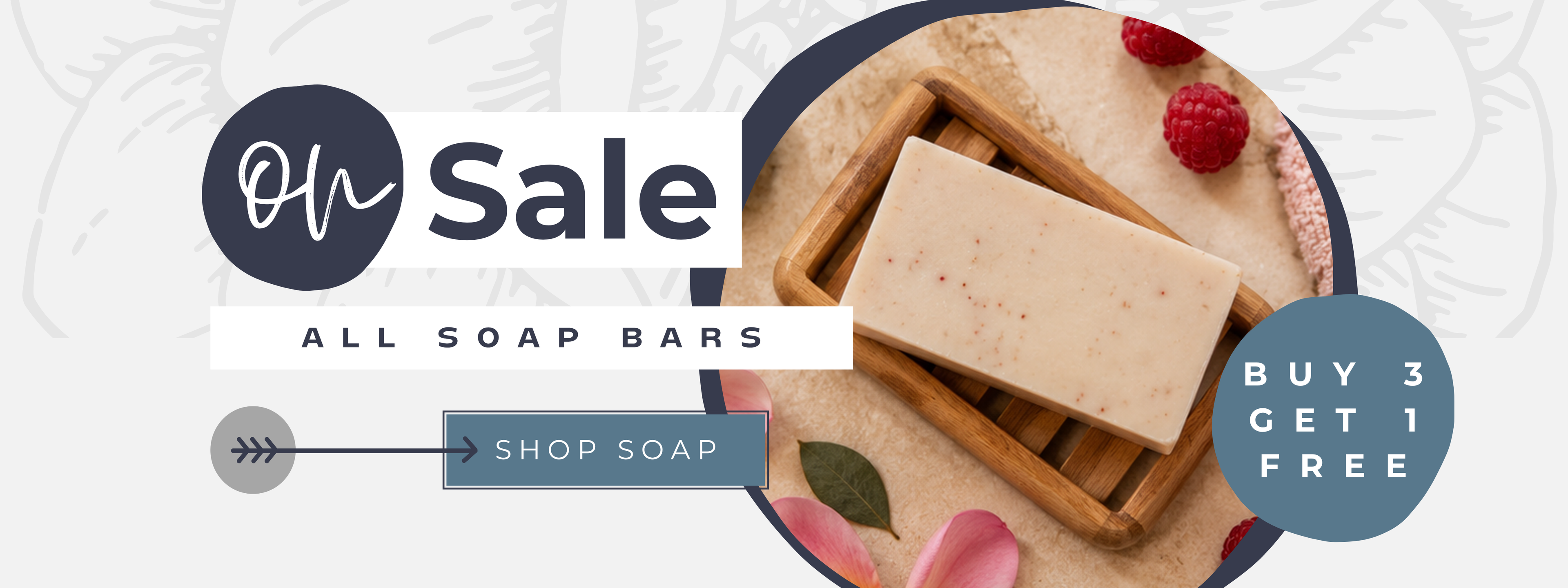 On sale, all soap bars, buy three get one free, shown with a speckled handmade soap bar on a wooden dish and fresh raspberries.