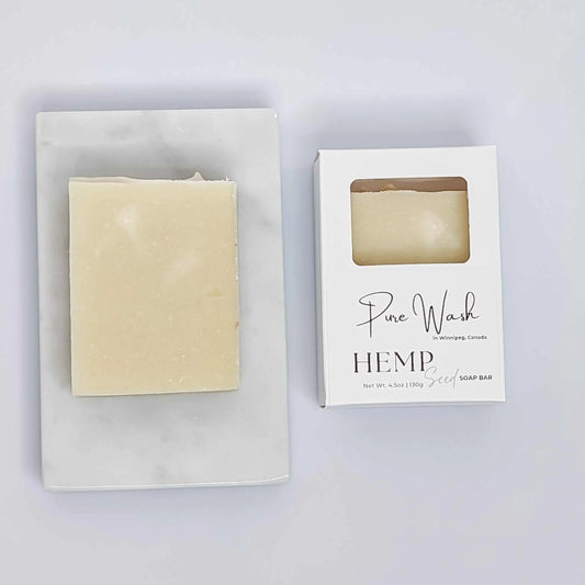 Hemp Seed Soap Bar on a marble tray with packaging, showcasing premium quality hemp seeds for nourishing skin care.
