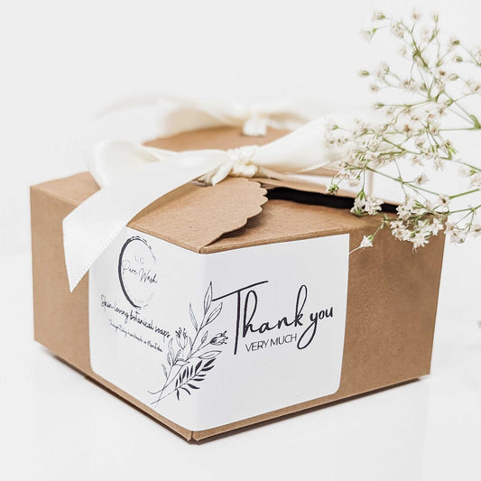 Handcrafted soap bars in lavender and cream hues, beautifully presented in a brown gift box with a white 'Thank You' tag