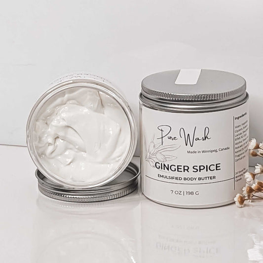 Hand dipping into a jar of Ginger Spice Emulsified Body Butter by CG Pure Wash, showcasing the product's smooth consistency.