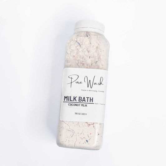 CG Pure Wash Milk Bath Soak bottle filled with coconut milk infused bath powder, presented on a pristine white background, highlighting the natural, handmade quality made in Winnipeg, Canada