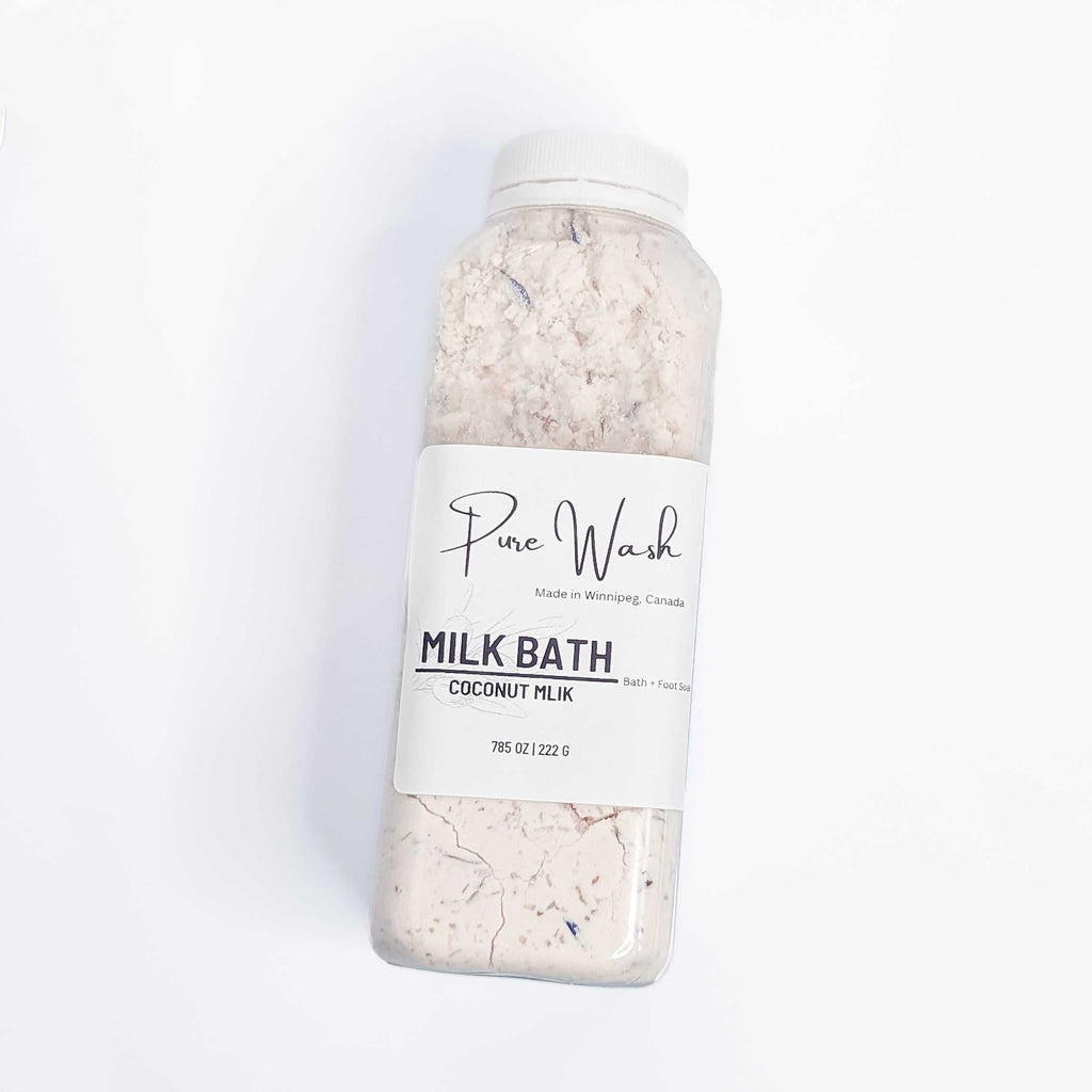 Milk Bath Soak in a clear bottle with a label, featuring coconut milk and pink Himalayan salt for skin rejuvenation and relaxation.
