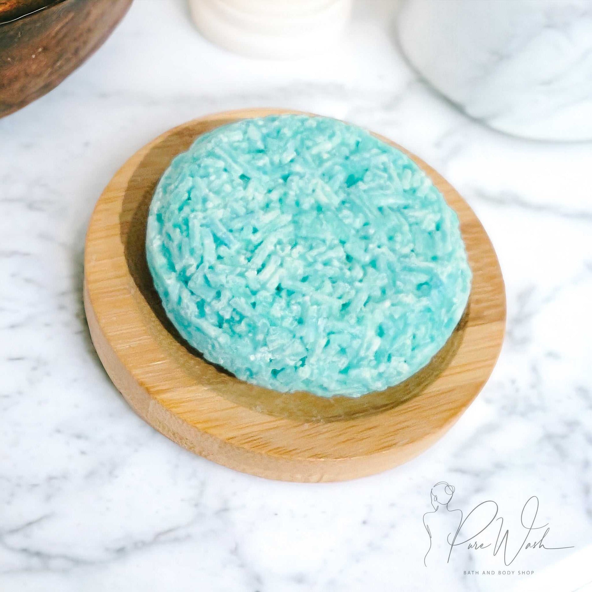 Handcrafted shampoo bar made with natural ingredients on wooden dish.