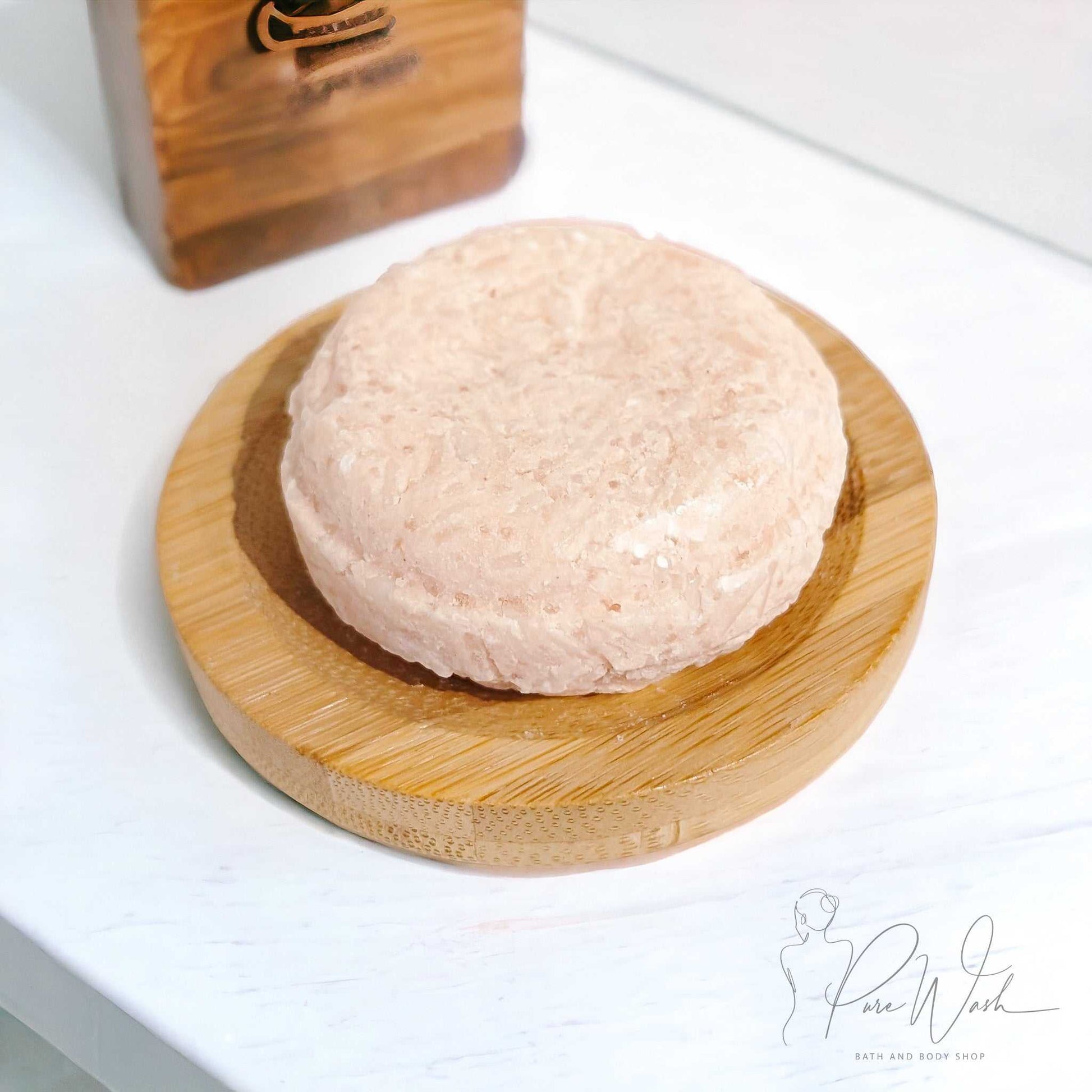 Handcrafted shampoo bar on a wooden dish, eco-friendly and suitable for all hair types.