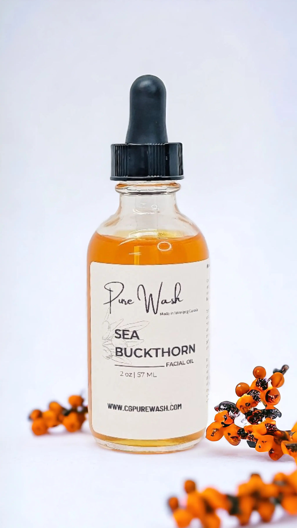 Sea Buckthorn Facial Oil bottle with dropper and sea buckthorn berries.