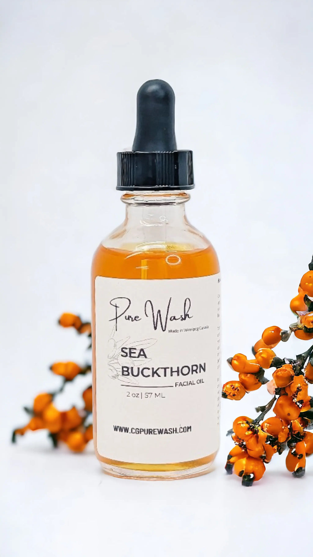 Sea Buckthorn Facial Oil in glass bottle with dropper, surrounded by sea buckthorn berries, for glowing and nourished skin.