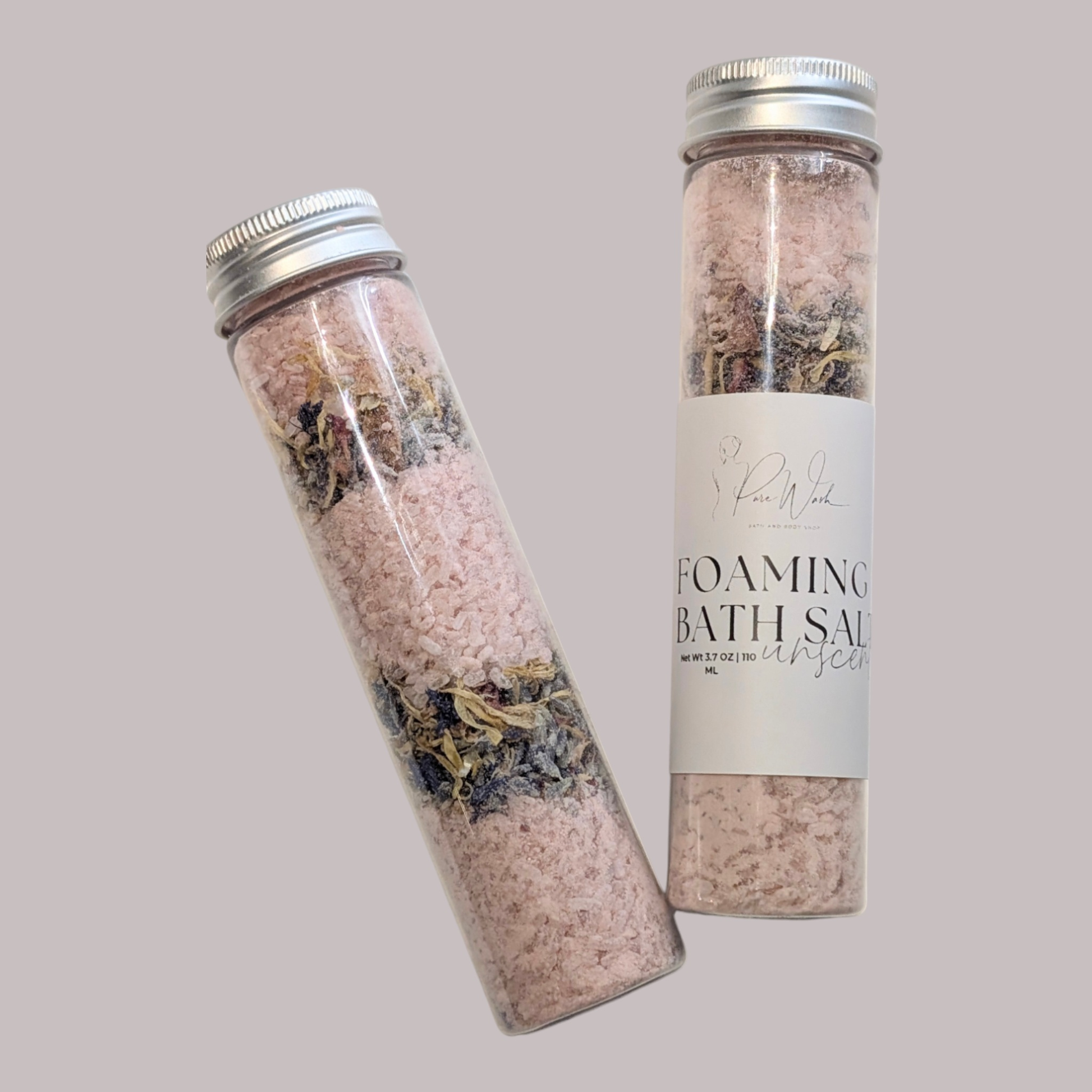 Foaming Bath Salts in clear jars with layers of pink salts and dried flowers, promising a luxurious and soothing spa-like experience.