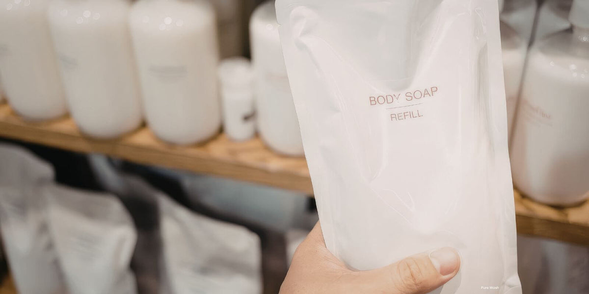 A translucent white refill pouch for body soap, labeled with minimalist black text