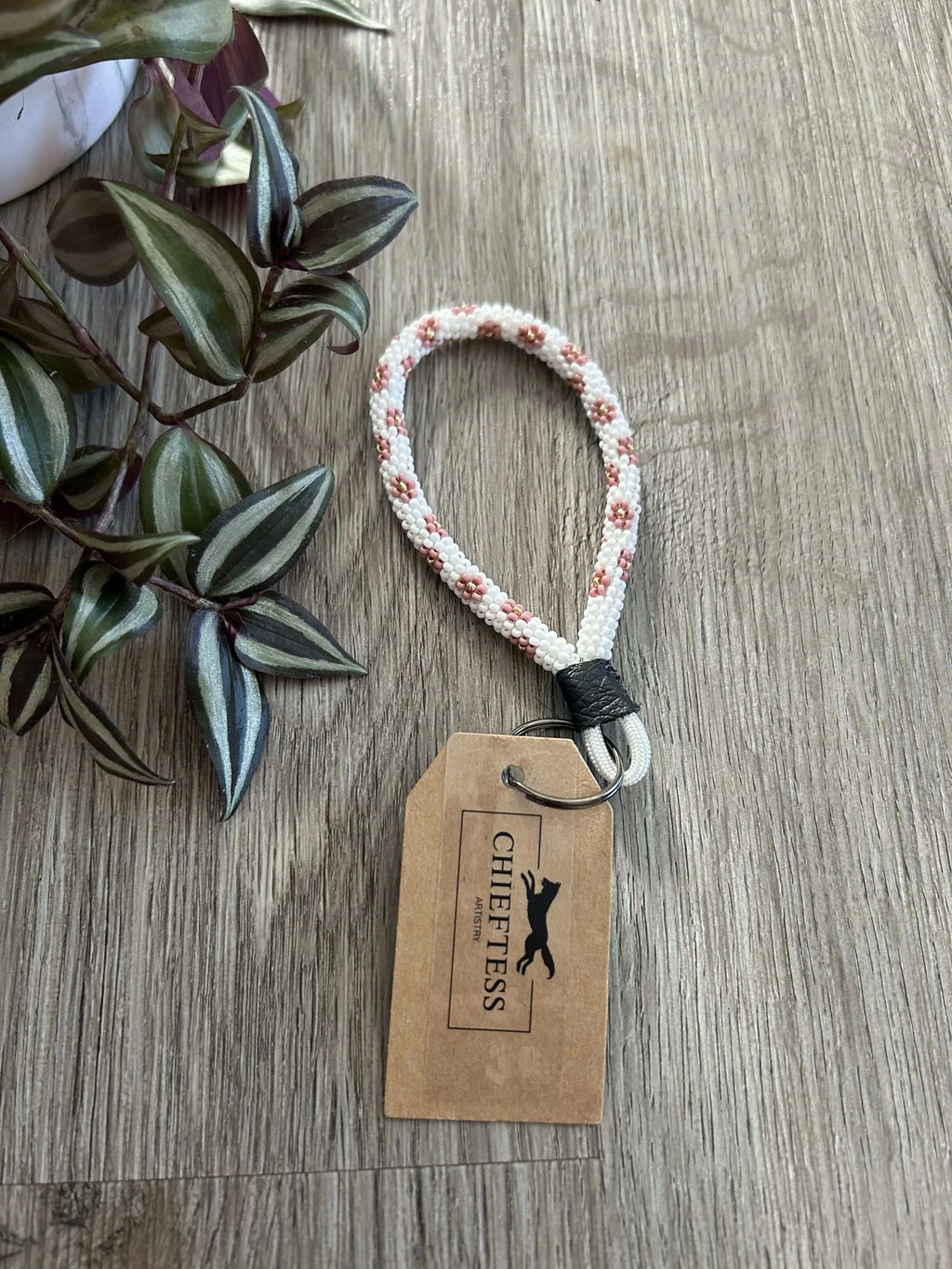FLORAL beaded mini keychain with bold flowers on white background, leather strap, and key ring, 4-inch length.