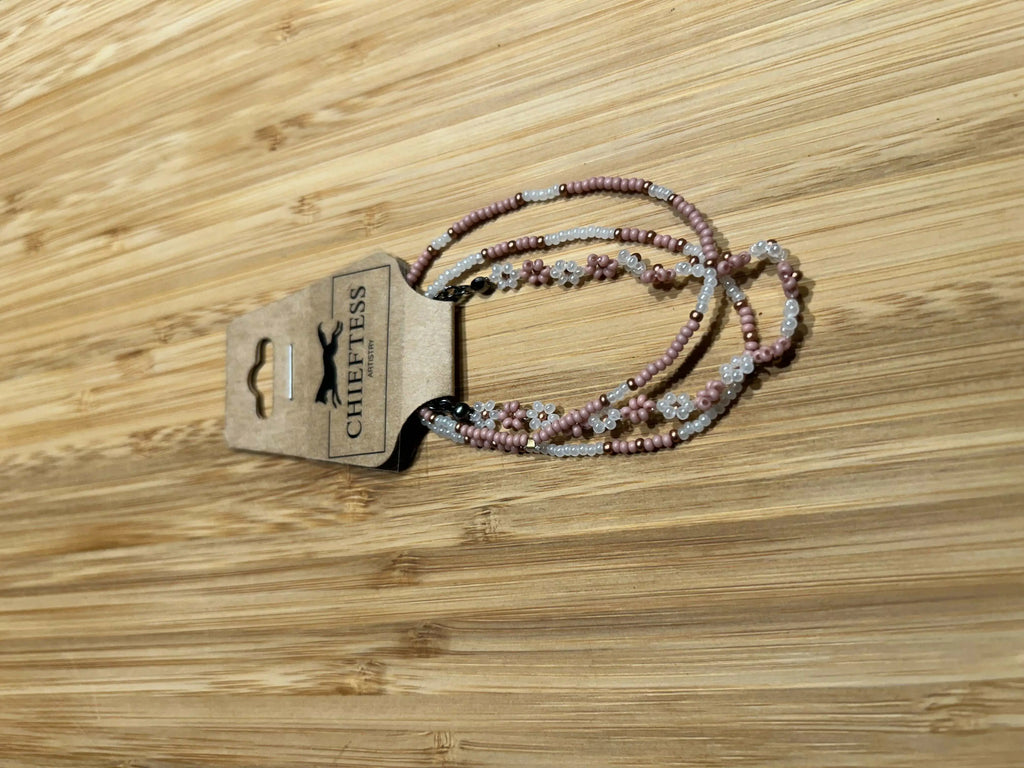 VIRAGO Beaded Bracelet Set with pink and white beads on a wooden surface.