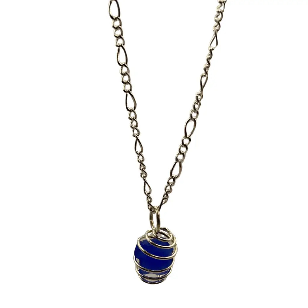 A delicate silver chain necklace with a beach glass caged pendant featuring vibrant blue enamel and intricate wire wrapping
