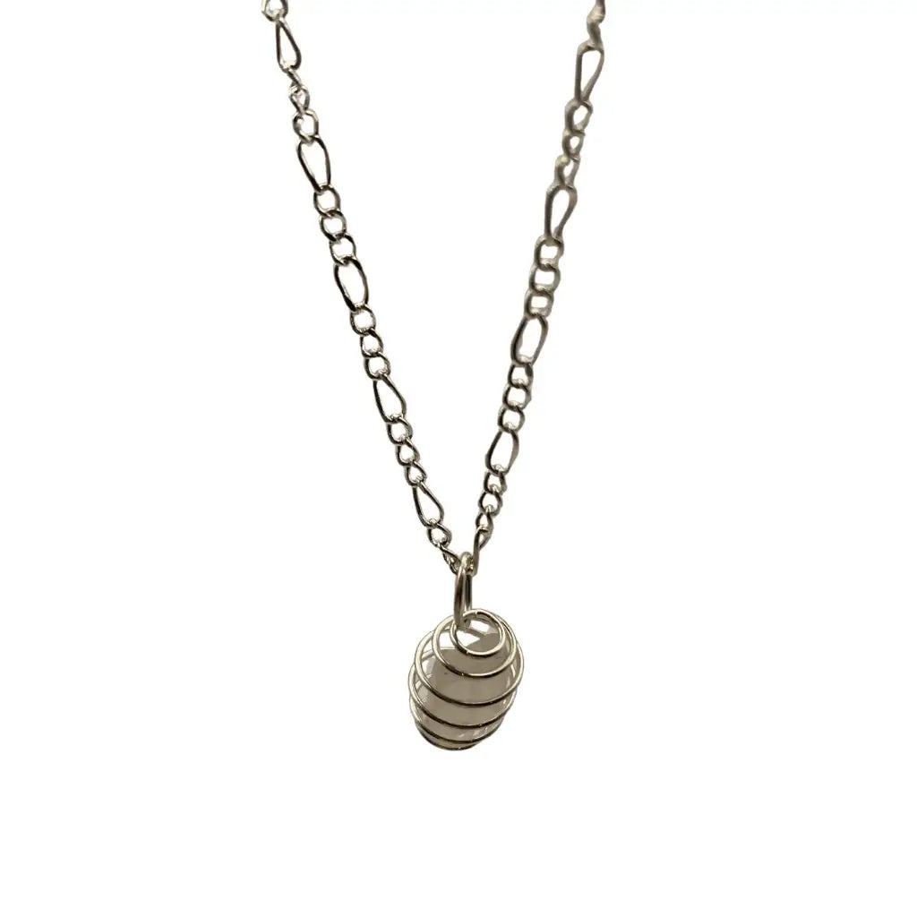 Silver chain necklace with a spiral metal ring pendant featuring green beach magic in a beach glass caged design