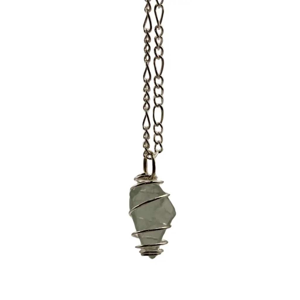 Silver-toned chain necklace with a pale green translucent beach glass pendant in a fine wire cage.