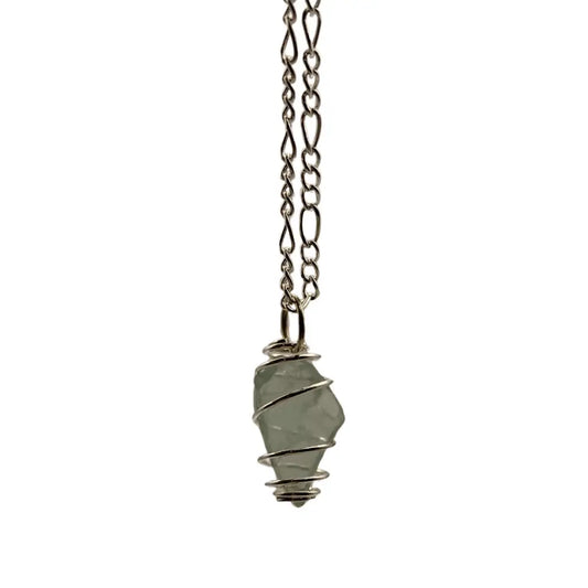 Silver-toned chain necklace with a pale green translucent beach glass caged pendant wrapped in fine wire
