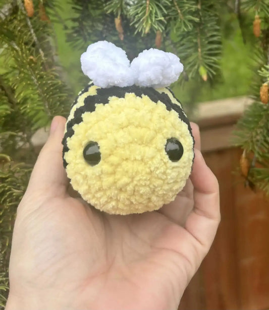 Handmade yellow and black crocheted bee ornament with fluffy white wings ideal for natural skincare Canada gifts