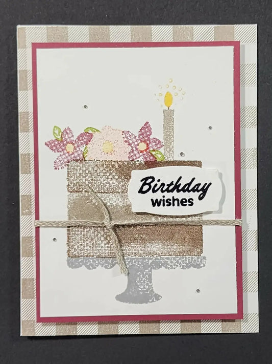 Handmade birthday cake card with glittery brown and silver layers, pink and purple floral embellishments, and a candle
