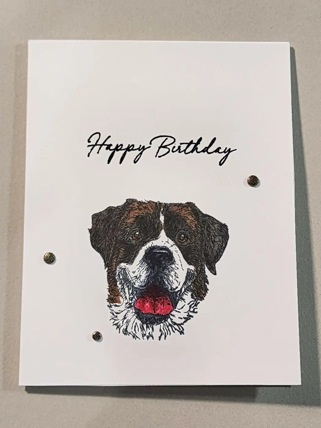 White birthday dog card featuring a detailed brown and white dog illustration with red tongue and three metallic brads