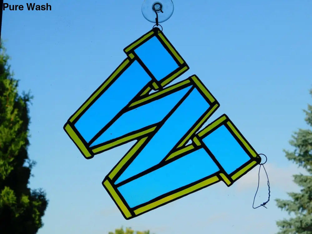Go Blue Go this colorful stained glass logo in Sky - blue, trimmed with gold colored glass, is an eye catcher at 8 1\2 in x 7 1\2 in . this could go in a window or sit on a shelf - Pure Wash Canadian Made - Winnipeg
