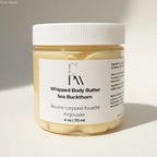 A clear glass jar with white lid contains creamy yellow sea buckthorn whipped body butter by Pure Mash