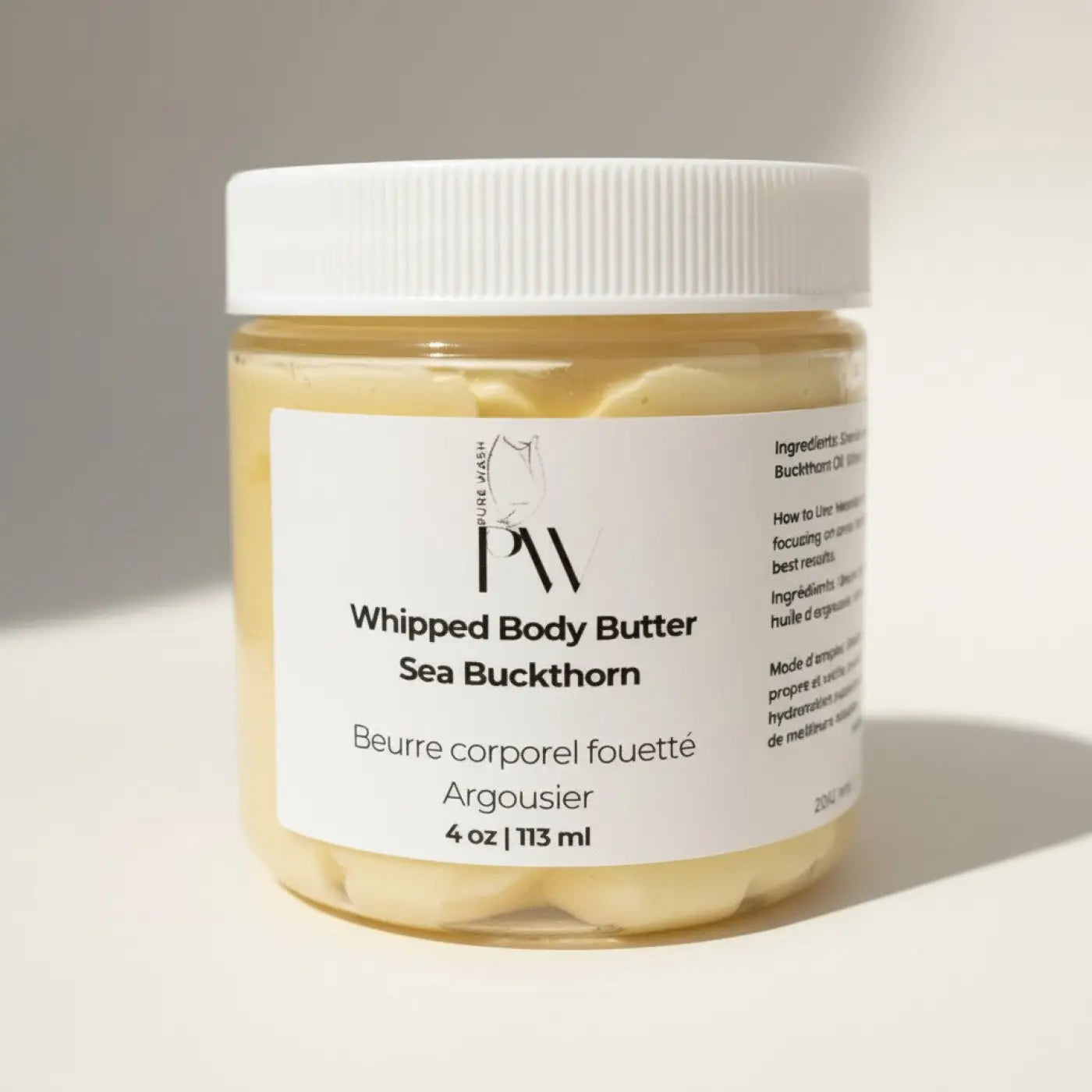 Pure Wash Sea Buckthorn Whipped Body Butter in a clear jar, creamy yellow texture, natural ingredients for deep hydration.