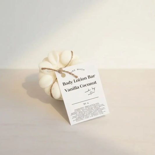 Cream-colored flower-shaped body lotion bar with natural twine tie and minimalist white tag solid moisturizer for pure wash