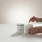 White ceramic jar with silver lid containing ultra-nourishing body lotion sugar plum by pure wok with shea butter