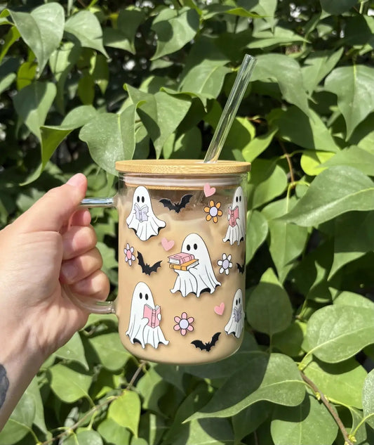 A clear glass bookish ghost mug with a bamboo lid and handle featuring white ghost, hearts, bats, and pastel flowers