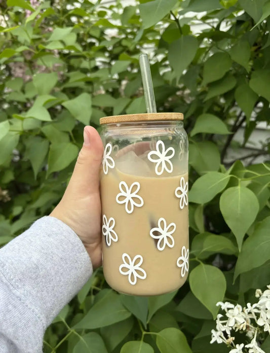 Clear glass flower glass mug with white floral decals bamboo lid filled with iced coffee botanical flower glass