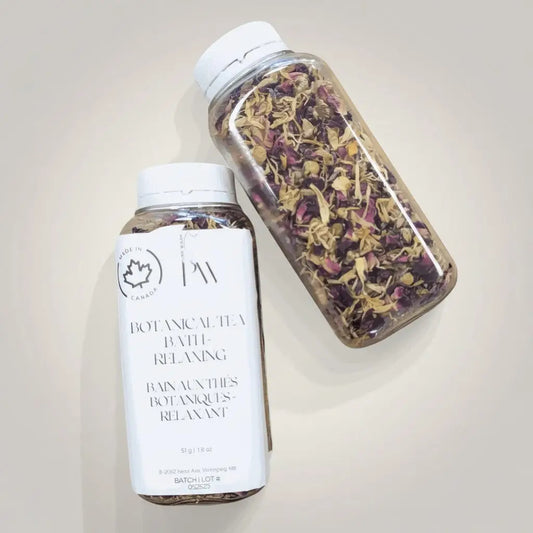 Clear plastic botanical tea bath bottle with dried rose petals chamomile and white cap herbal bath soak by canadian brand