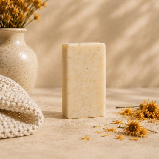 Cream-colored calendula soap bar with dried calendula flowers supports healthy skin and soothes easily irritated skin