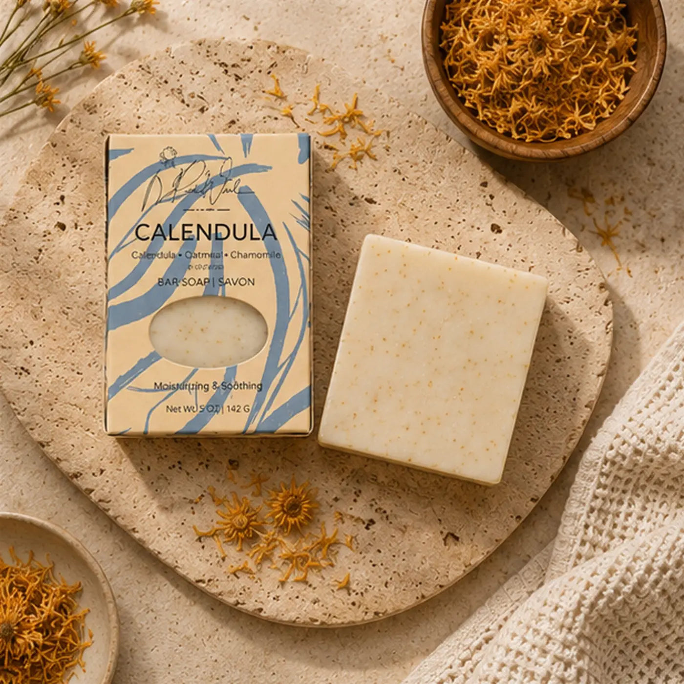 Cream-colored speckled calendula soap bar by rachel ash supports healthy skin and soothes easily irritated skin